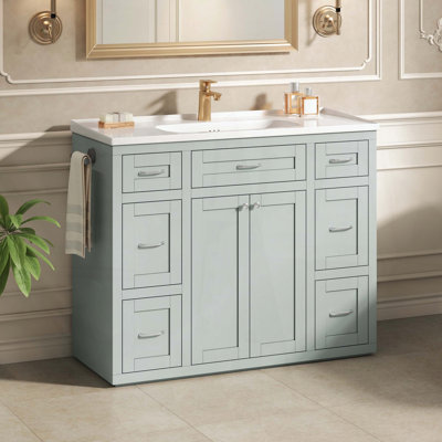 Meuble-lavabo sur pied avec lavabo en céramique, six tiroirs, tiroir central rabattable, portes doubles à fermeture amortie et porte-serviettes réversible, vert menthe