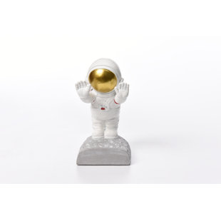 'a statue of a astronaut with a gold helmet'
