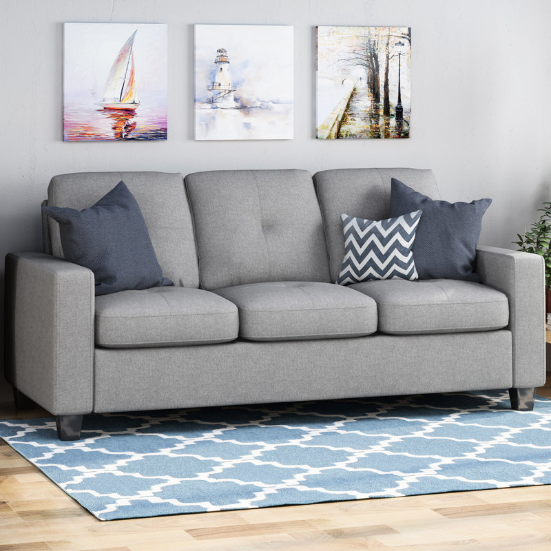 Trois avec pieds en bois - Tissu gris reposant sur une solution de détente