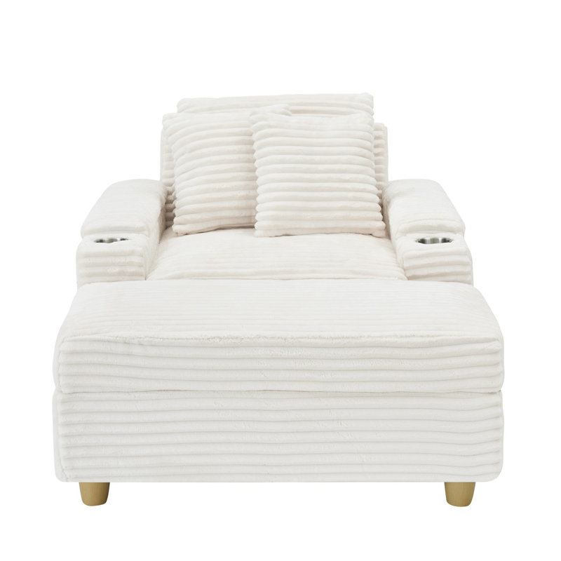 Canapé blanc simple en velours côtelé avec un coussin, deux coussins décoratifs, un repose-pieds et deux espaces de rangement.