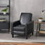 Fauteuil à dossier poussoir en cuir noir pour une décoration intérieure élégante