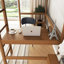 Lit mezzanine fonctionnel avec bureau intégré, structure rembourrée, échelle et garde-corps de sécurité pour une chambre confortable et pratique