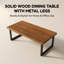 Modern solid wood dining table with a walnut-coloured wood finish and metal legs-129390958