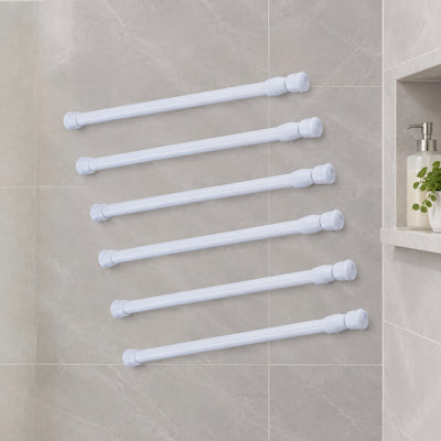 Six white steel spring-tension cupboard bars, each adjustable from 9.8 to 15.7 inches; the 6 pack can be used as tension curtain rods, shower rods, closet rods, or window rods.