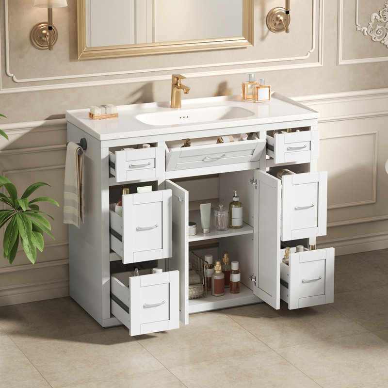 Meuble-lavabo blanc 48 po avec lavabo en céramique - 6 tiroirs (3 de chaque côté), tiroir central rabattable, portes doubles à fermeture en douceur, porte-serviettes latéral réversible, poignées argentées, panneau de fibres à densité moyenne