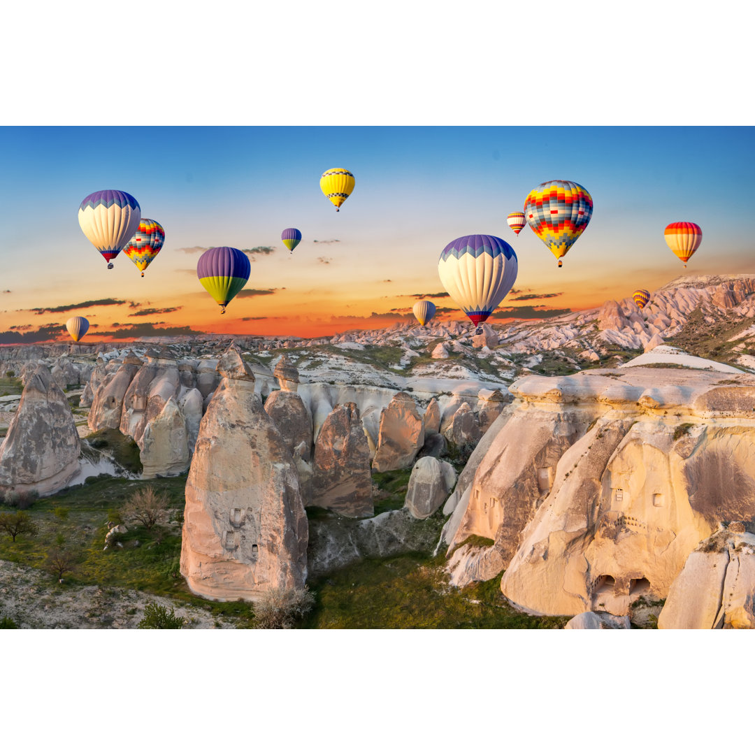 Hot Air Balloons At Sunset Over The Cave Town, Cappadocia, Turkey
