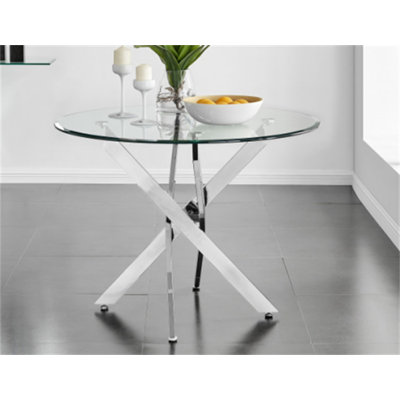 Le plateau de table circulaire moderne en verre trempé est jumelé à un cadre en fer argenté