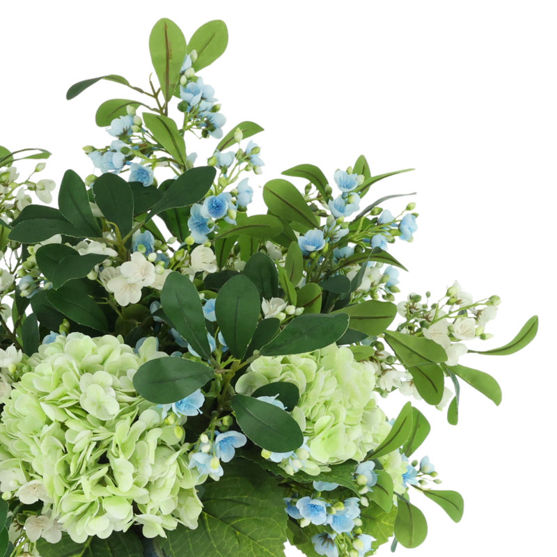 Hortensias et tiges en herbe dans un vase décoratif