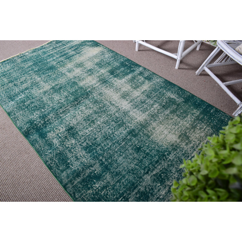 Tapis turc à motif rétro vert idéal pour décorer le salon
