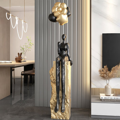 Objet décoratif en résine noire et dorée