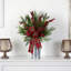 Arrangement de Noël avec nœud dans un vase décoratif