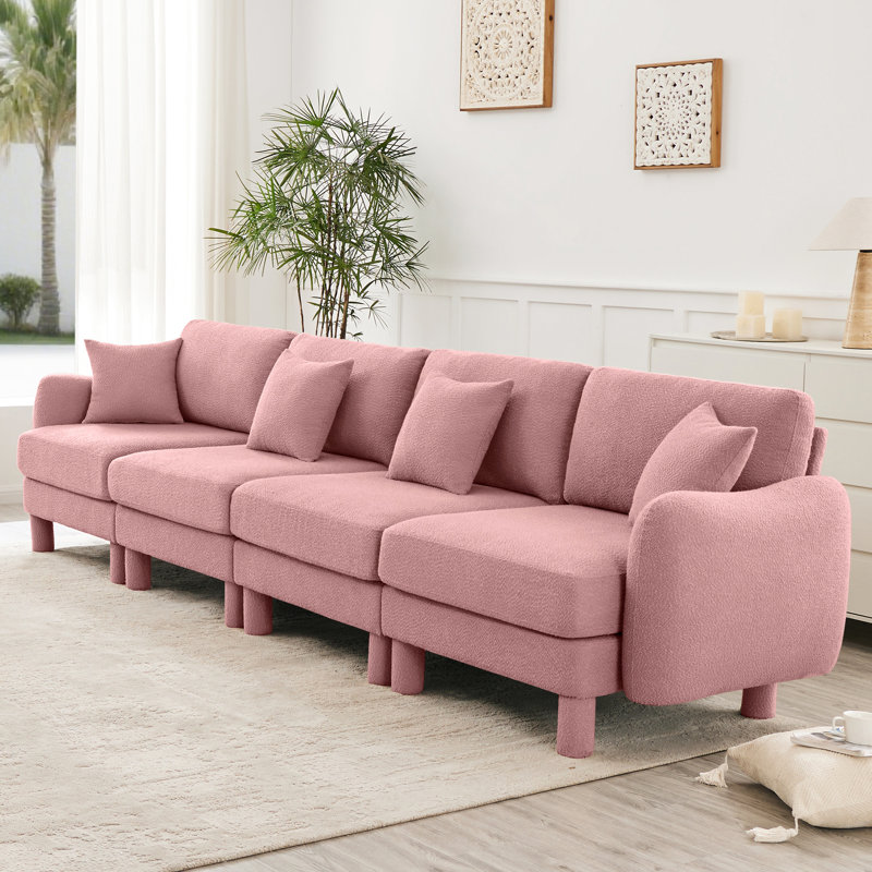 Tissu bouclé rose à 4 places avec sièges élégamment courbés et supportés par des ressorts pour un endroit confortable et moderne avec des pieds cylindriques en tissu