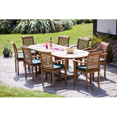 Hartridge 8 - Person Teak Solid Wood Patio Dining Set Extendable Oval Table with Cushions Included