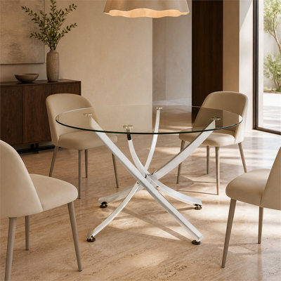 A round dining table with a tempered glass tabletop and a chrome-plated star-shaped base is sturdy, easy to clean, and suitable for everyday dining and entertaining occasions.