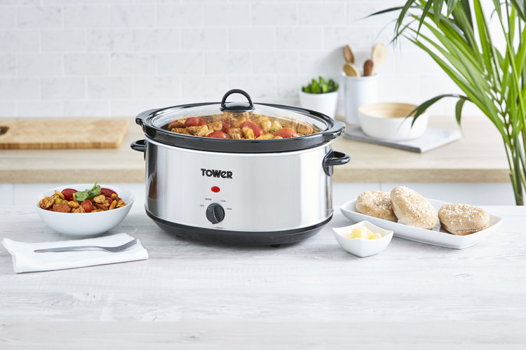 Stainless steel slow cooker on a white kitchen countertop