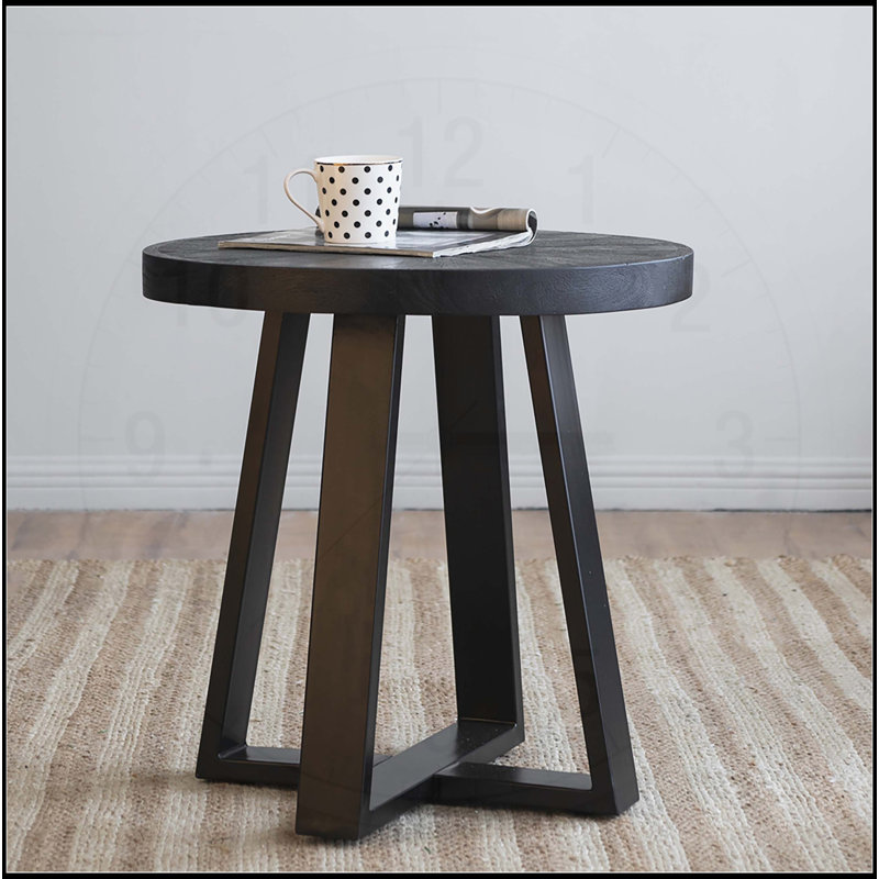 Table basse élégante et fonctionnelle avec surface arrondie et structure moderne à pieds croisés
