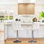 Ensemble de tabourets de bar pivotants en cuir Vegan-107167924-134155460