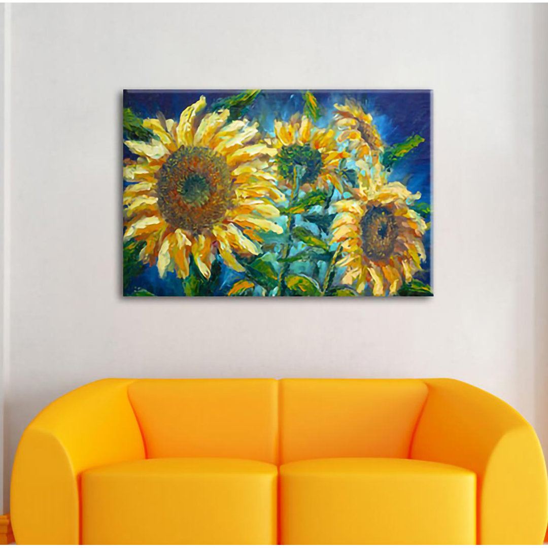 Leinwandbild Sonnenblumen vor blauem Hintergrund