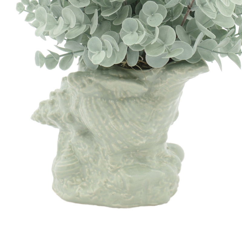 Eucalyptus Arrangement In A Shell Vase.