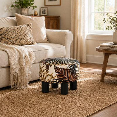 Pouf ottoman rond rembourré à motif botanique avec pieds noirs