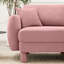 Canapé 3 places en tissu rose avec des pieds cylindriques et distinctifs, confortable pour les séances de lecture