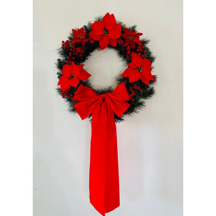 Beautiful Red Poinsettia and Berry Christmas Wreath with a stunning red velvet bow.