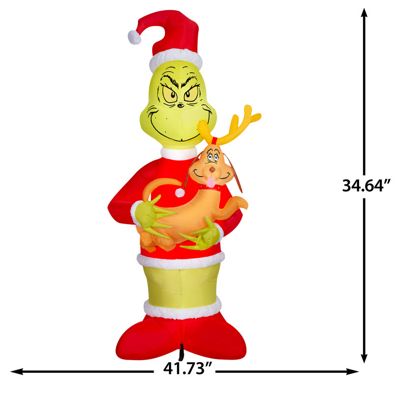 Grinch soufflé à l'air tenant une scène géante du Dr Seuss