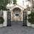 Verduzco Metal Indoor Outdoor Scrollwork Arched Gate Black Garden Arbor with Vines and Latch Lock Closure