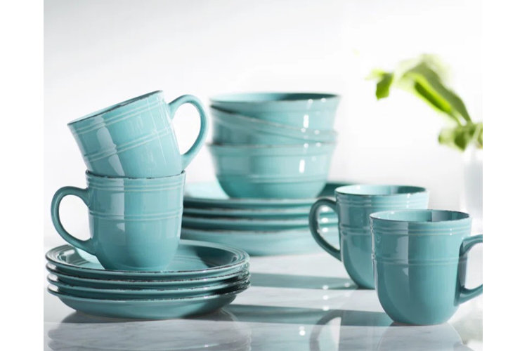 Blue 16-piece dinnerware set on a white table