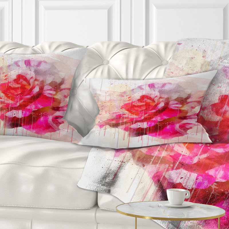 Coussin lombaire floral rose avec des éclaboussures d’aquarelle