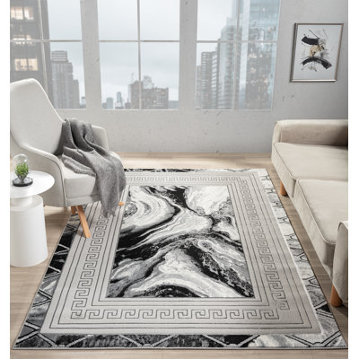 Tapis à bordure abstraite gris / noir de la collection Ksamil