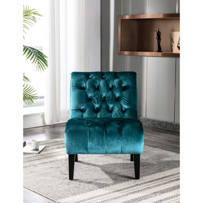 Chaise en velours bleu sarcelle avec coussin résilient pour une détente relaxante