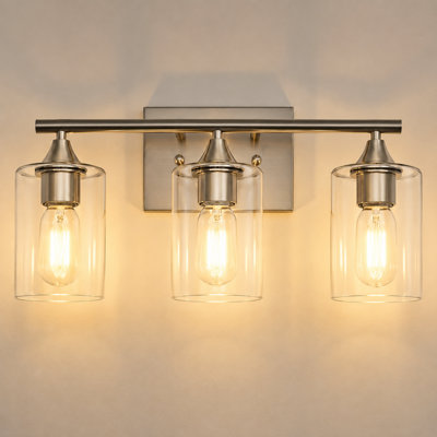 Éclairage pour salle de bain 3 lumières en nickel brossé avec abat-jour en verre transparent et fixation murale réversible