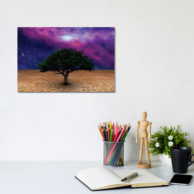 Green Tree In Arid Land With Galactic Disk In Night Sky by Bruce Rolff - Wrapped Canvas Print