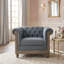 Fauteuil club capitonné avec garniture cloutée