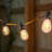 Ambience Pro 27 ft. Solar Outdoor Patio LED String Lights with 12 Warm White Flame-Effect S14 Bulbs, Weatherproof
