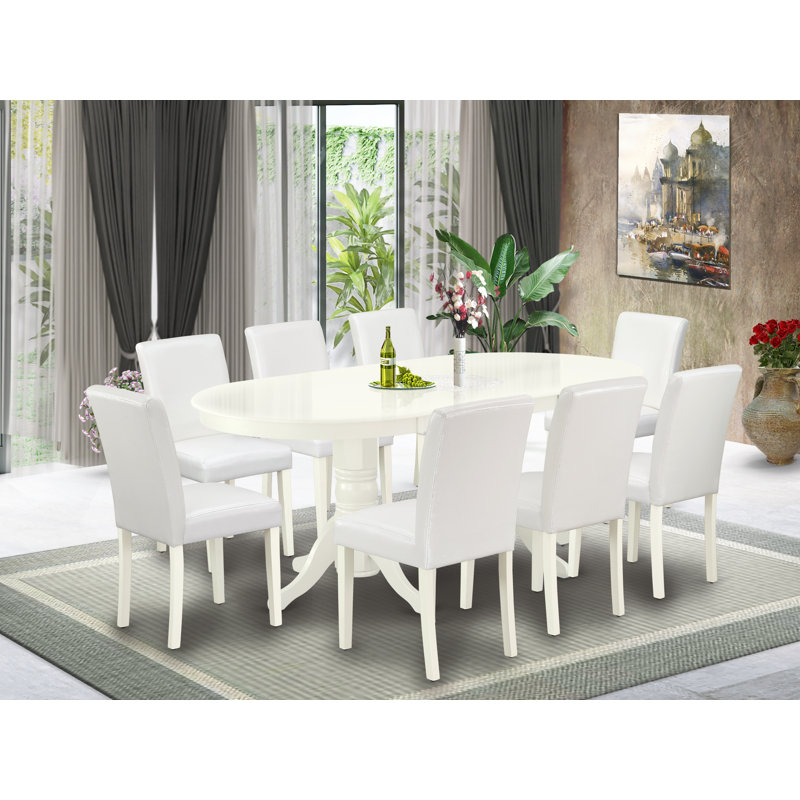 L'ensemble de salle à manger 5 pièces comprend une table de salle à manger ovale avec rallonge papillon et 4 chaises Parson revêtues de similicuir blanc, lin blanc