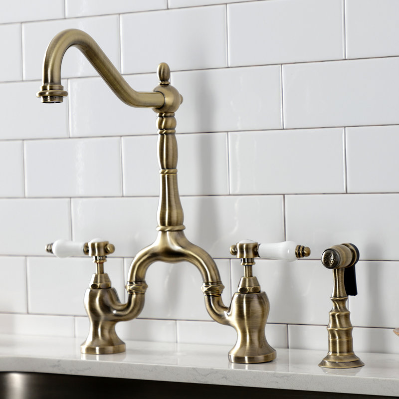 Kingston Brass Heirloom Two-Handle 3-Hole Deck Mount Bridge Kitchen Faucet with Brass Side Sprayer, Antique Brass