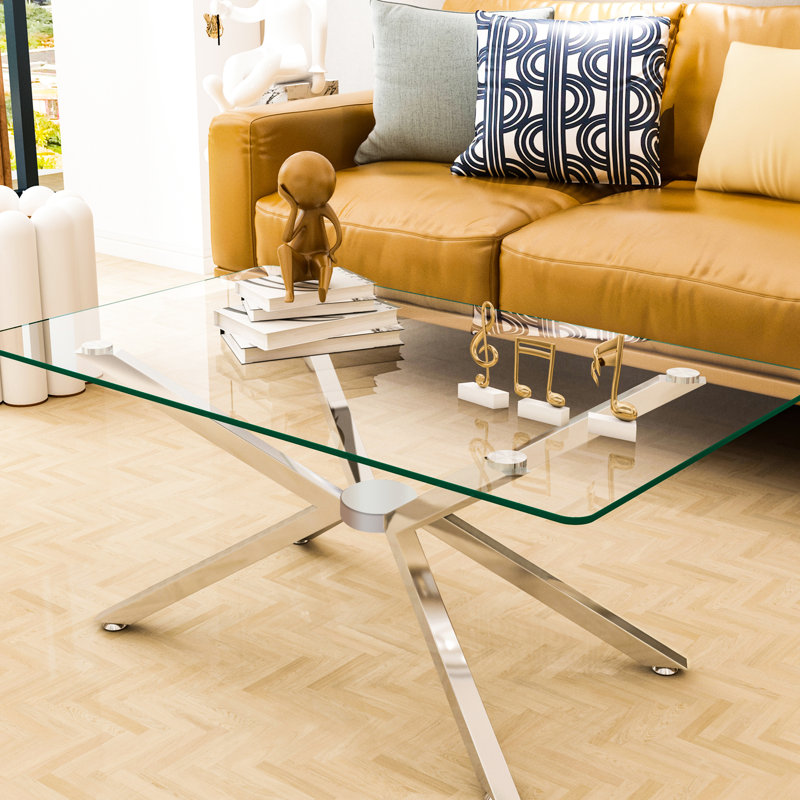 Table basse rectangulaire de 102 cm (40,21 po) en verre trempé transparent, de haute qualité, avec pattes en métal argenté. Idéale pour le bureau, cette table en verre rectangulaire est facile d'entretien et robuste, supportant les objets lourds. Son design moderne lui donne un style unique.