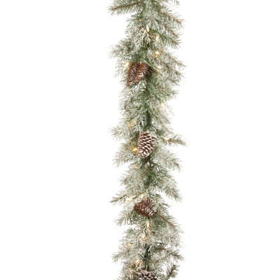 The Holiday Aisle® 9 ft. Frosted Mountain Spruce Garland with Clear Lights