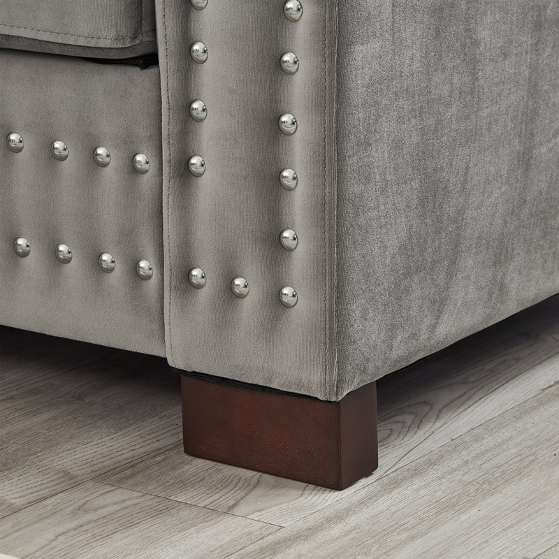 Canapé de salon moderne et élégant avec accoudoirs carrés et décoration cloutée, revêtu de velours pour un confort ultime
