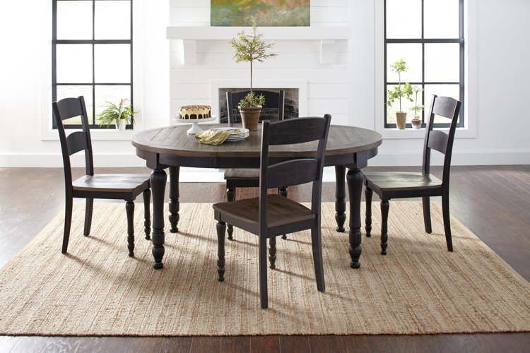 four modern farmhouse dining chairs around a circular dining table