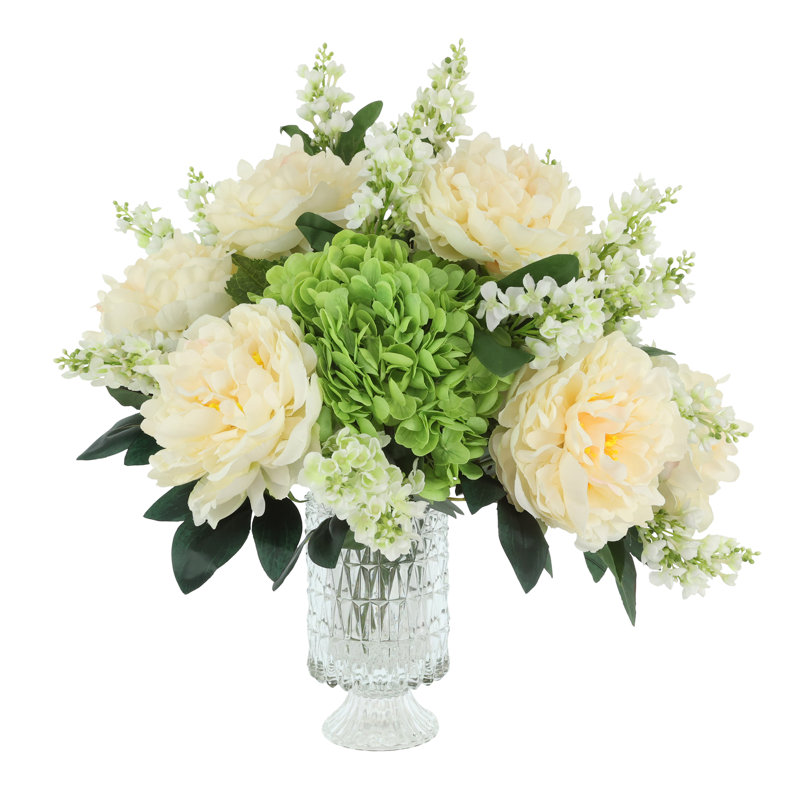 Centre de table à fleurs mélangées dans un vase en verre