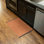 Tapis orange lavable à la machine Breneisha