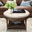 Table basse ronde avec pattes en bois - Revêtement en lin beige et blanc et rangement