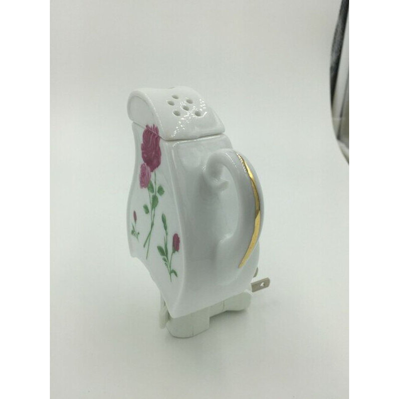 Roses sur une théière en forme de veilleuse