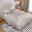 Cream-colored upholstered boucle bed with a rounded arched headboard styled in a bedroom setting.