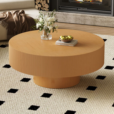 Table basse ronde avec plateau extra épais et piètement minimaliste
