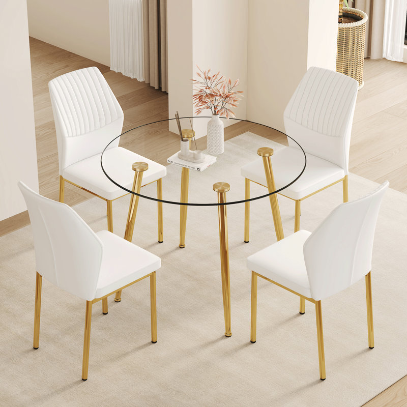 Ensemble de salle à manger luxueux en verre moderne avec cadre en métal doré parfait pour les espaces élégants