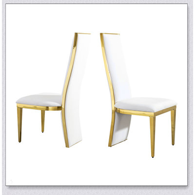 Elegant Gold Stainless Steel Dining Table Set with White Fabric Chairs, Perfect for Contemporary Interiors and Small Spaces.